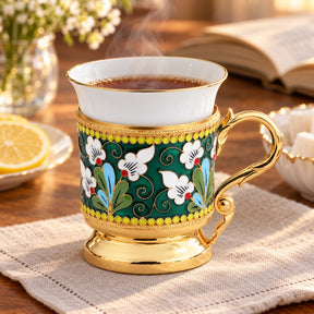 Kaffeetasse aus Porzellan & Silber mit Emaille-Blumendekor — Lifestyle-Setting am Teetisch